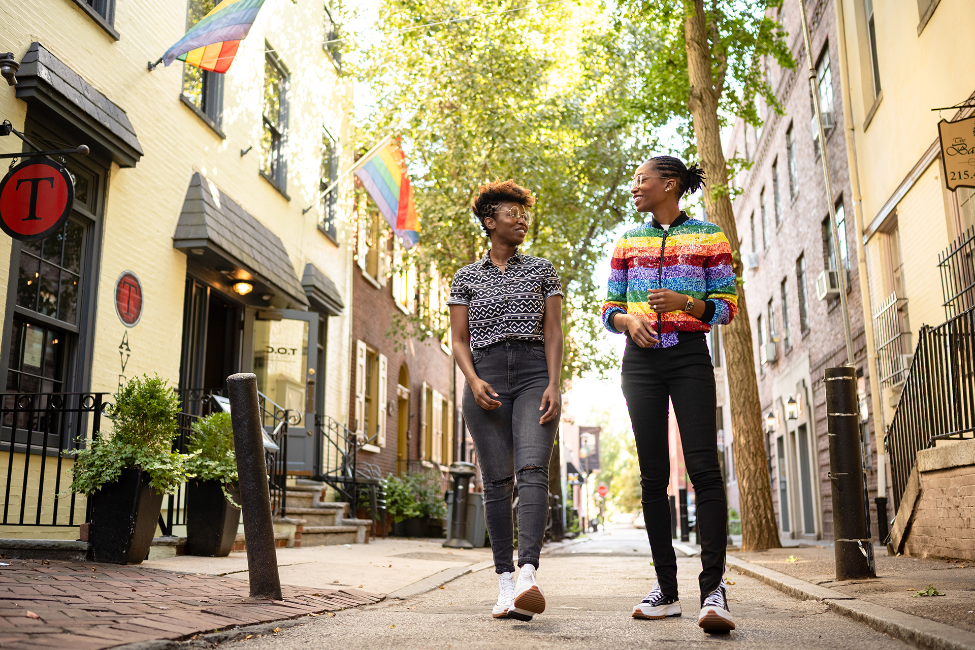 A couple walks down one of Philadelphia's tree-lined streets.
