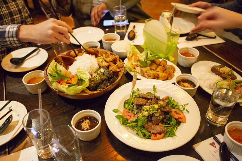 Rice vermicelli, spring rolls, beef-stuffed grape leaves and fried shrimp comprise an appetizer platter (left); while Shaking Beef, also known as Bo Luc Lac, beef cubes sautéed with soy sauce, garlic and scallion and finished with oyster sauce, is a main course at Vietnam Cafe in University City and Vietnam in Chinatown, both in Philadelphia.