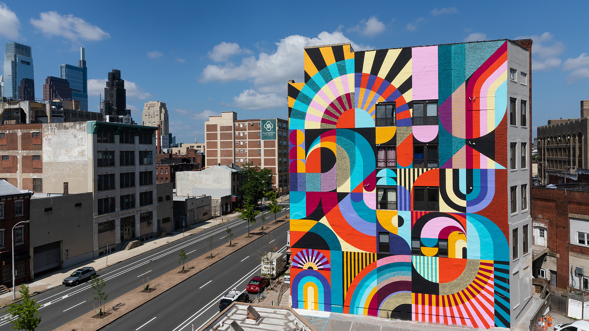 A vibrant mural made up of shapes on the side of a building in Philadelphia.