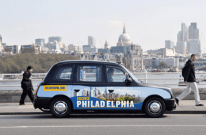A rendering of a London cab wrapped in Discover PHL branding,