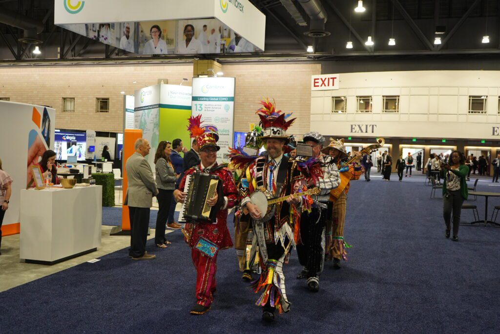 A group of Mummers walk through the CPHI convention hall at the Pennsylvania Convention Center.