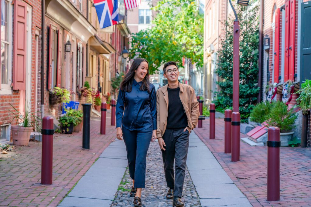 Two people walking towards the camera on Elfreth's Alley