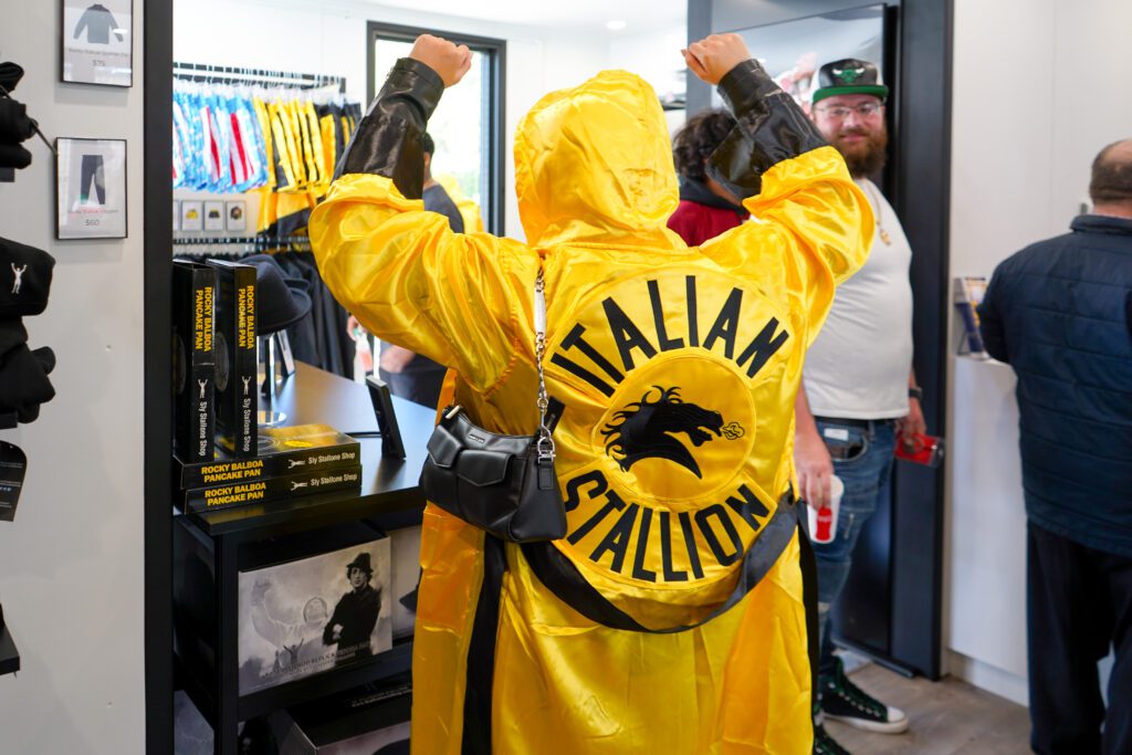 A person wearing a yellow Italian Stallion robe in the Sly Stallone Shop.