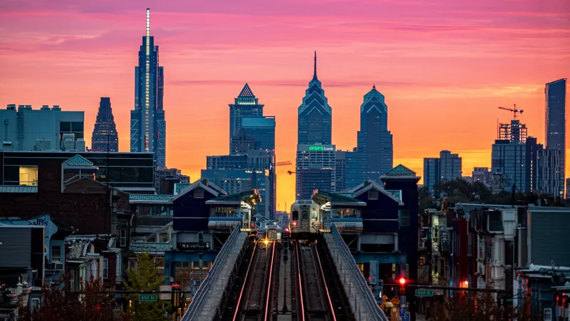 Photo of Philadelphia's skyline at sunset from an elevated subway platform.