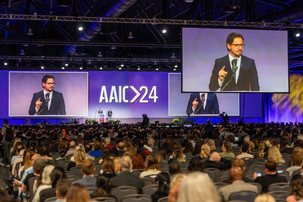 A speaker addresses the crowd at AAIC24.