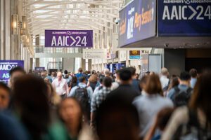 Crowded hallow under signs that say AAIC