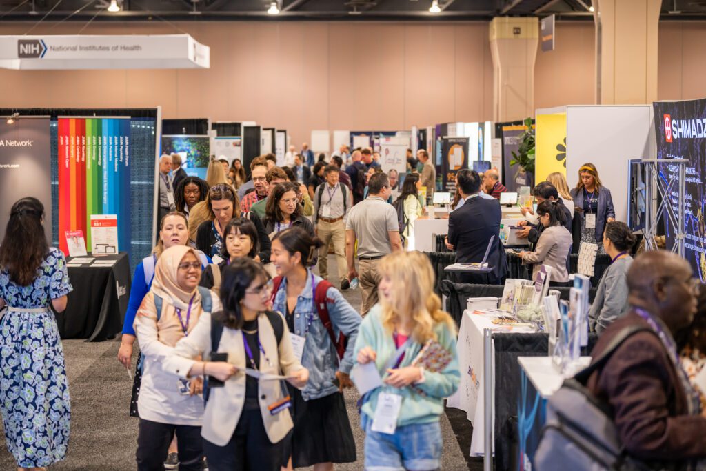 Attendees in the exhibition hall of AAIC24 at the Pennsylvania Convention Center. 