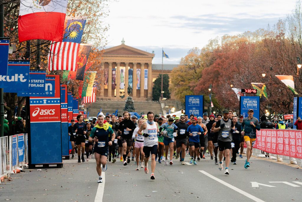 A group of Philadelphia Marathon runners running in front of the Philadelphia Art Museum. 