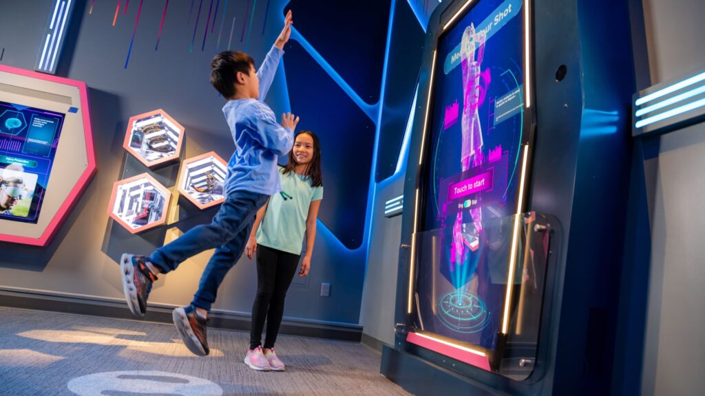 Two kids playing in the Body Odyssey exhibition at The Franklin Institute